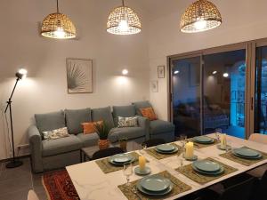 a living room with a table and a couch at LA MAISON BARNOIN - gîtes et chambres in Bouyon