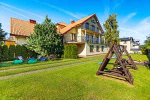 a house with a playground in the yard at Willa Chantal in Jastrzębia Góra
