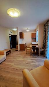 a living room with a couch and a table at Hotel Seasons 3 in Sunny Beach
