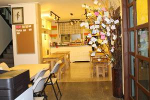 a restaurant with tables and chairs and a kitchen at Nabizam Motel in Yeosu