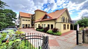 a large house with a fence in front of it at Willa Chantal in Jastrzębia Góra