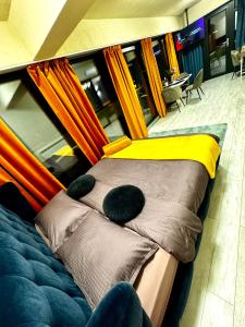 a bed in a room with umbrellas at PENTHOUSE EXCLUSIVE VIEW , Iasi in Iaşi