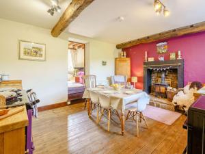 a dining room with a table and a fireplace at 3 Bed in Kirkby Stephen 88517 in Outhgill