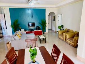 a living room with a couch and a table at Samal Island Garden Villa - Spacious 3BR, AC, Wi-Fi, Indoor-Outdoor Kitchens in Caliclic