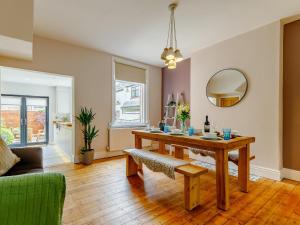 a living room with a wooden table and a mirror at 3 Bed in Chapel-En-Le-Frith 88180 in Chapel en le Frith