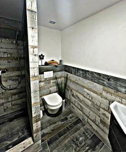 a bathroom with a toilet and a sink at O5 residence in Nivy