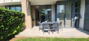 a table and chairs on a patio outside of a house at Menlyn Maine Trilogy Penthouse 42 in Pretoria