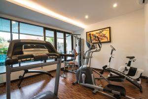 a gym with two exercise bikes and a treadmill at Lani Chiang Mai Hotel in Chiang Mai