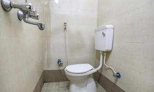 a bathroom with a toilet and a shower at FabHotel Lily Grand in Kakarmatha