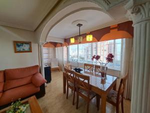 a living room with a table and chairs and a couch at Urbanizacion Condor in Benidorm