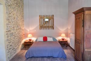 a bedroom with a bed and two lamps on two tables at Domaine de la Palombe in Villiers-Fossard