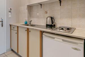 a kitchen with a sink and a stove at Alexandros Apartments in Ipsos