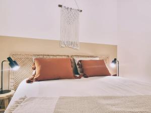 a bedroom with a large white bed with two pillows at Shorebreak Nieuwpoort near the beach in Nieuwpoort-Bad