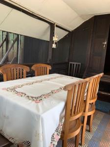 a table with a white table cloth on it at HOMESTAY Kampong KOTA AUR Resort with swimming pool, Kepala Batas, SEBERANG PERAI, PENANG -MOTAC registered Awarded ASEAN homestay standard Malaysia AWARD 2023-2025 Only 3 minutes from viral KG AGONG in Kepala Batas