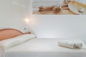 a bedroom with a bed with a picture on the wall at HOTEL AURORA in Cattolica