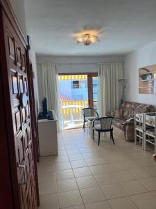 a living room with a couch and a table at Atlantic View Apartment Los Cristianos At Marysol Hotel Tenerife in Arona