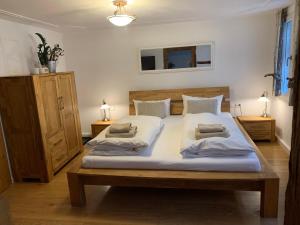 a bedroom with a large bed with two pillows on it at Gästehaus am Plönlein in Rothenburg ob der Tauber