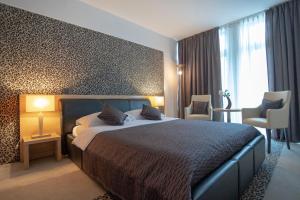 Postel nebo postele na pokoji v ubytování ZOO hotel