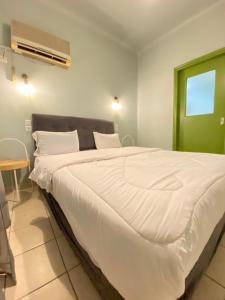 een slaapkamer met een groot bed met witte lakens bij Athens City Themis 5 in Athene