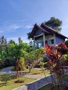 a small house in the middle of a garden at Alamku Bungalow in Tirtagangga
