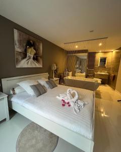 Schlafzimmer mit einem großen weißen Bett und einem Bad in der Unterkunft Mon petit Bali in Maussane-les-Alpilles