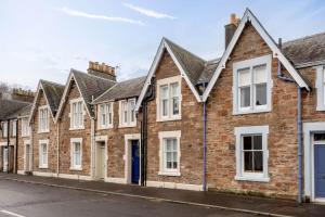 a row of brick houses on a street at Park Place Elie, Perfect for the beach in Elie