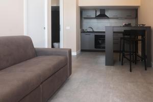 a living room with a couch and a kitchen at LEMON SUITES APARTMENTS in Rome