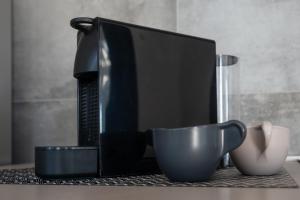 a computer monitor and a cup on a table at LEMON SUITES APARTMENTS in Rome