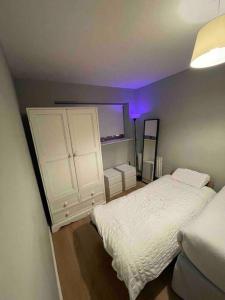 a bedroom with a white bed and a purple light at In Dublin's Best Tourist Spot Temple Bar in Dublin