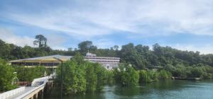 a building on the side of a river at Pearl Andaman Resort Ranong Koh Koo 