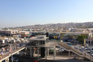 a city with a bridge and a parking lot with cars at Melidium Hotel in Beylikduzu