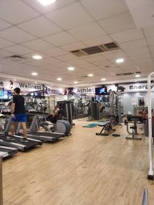 a gym with people exercising on treadmills and machines at דירה עם נוף לים בנאות גולף בריכה , ספא , חדר כושר in Caesarea