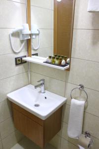 a bathroom with a sink and a mirror at Melidium Hotel in Beylikduzu