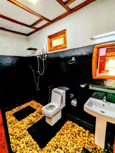 a bathroom with a toilet and a sink at Maika safari lodge in Udawalawe