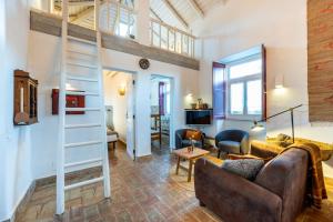 a living room with a couch and a loft at Casa dos Cantoneiros in Aljezur