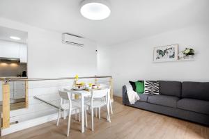 ein Wohnzimmer mit einem Tisch und einem Sofa in der Unterkunft Liomor Luxury in Caleta de Fuste