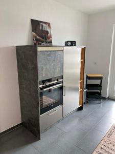 a stainless steel refrigerator with an oven in a kitchen at Ferienwohnung Flussufer No.12 in Schweich