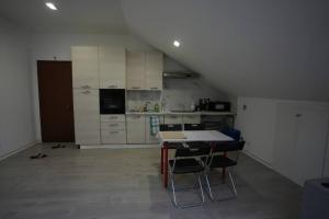 - une cuisine avec une table et des chaises dans la chambre dans l'établissement ClaRo Appartamento intero, à Limbiate