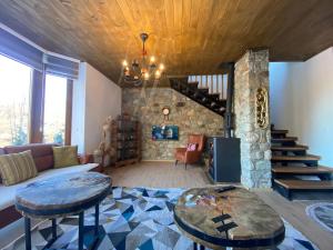 a living room with a couch and a table at Villa Gjelbër in Prizren