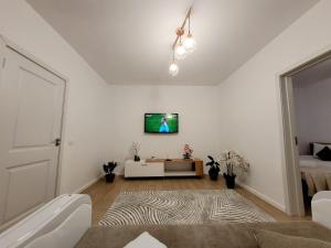 a living room with a tv on a white wall at Casa Feli in Braşov