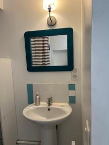 y baño con lavabo y espejo. en Studio Chambre voutée en Provence, en La Bastidonne