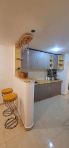 eine große Küche mit einer Theke und Stühlen in der Unterkunft Alia in Oradea
