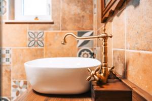 a bathroom with a white sink on a wooden counter at Posest Kunigunda in Šmartno v Rožni Dolini