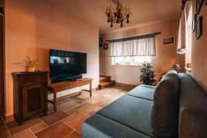 a living room with a couch and a flat screen tv at Posest Kunigunda in Šmartno v Rožni Dolini