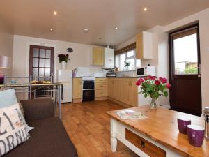 a large kitchen with a table and a couch at 1 bed in Burnham-on-Sea ALOLD in Highbridge
