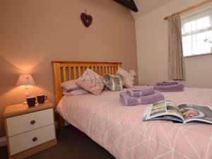 a bedroom with a bed with a book on it at 1 bed in Burnham-on-Sea ALOLD in Highbridge