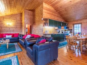 a living room with leather couches and a kitchen at 4 Bed in Clovelly 00356 in Clovelly