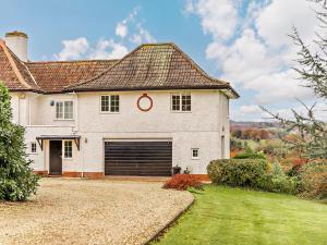a large white house with a garage at 1 Bed in Sidmouth HAYES in Newton Poppleford