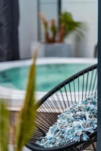a bench with a plant in front of a pool at Villa Cecha B&b &Wellness in Ostend