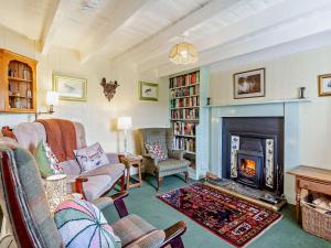 a living room with a fireplace and a fire place at 3 bed in Helmsdale SU192 in Helmsdale